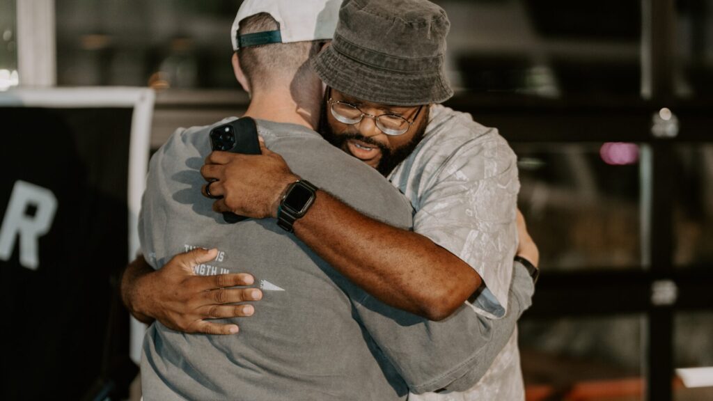 two men hugging at a scatter joy event in columbus ohio